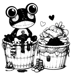 Two baskets of laundry with a stuffed animal frog sitting on top of the laundry
